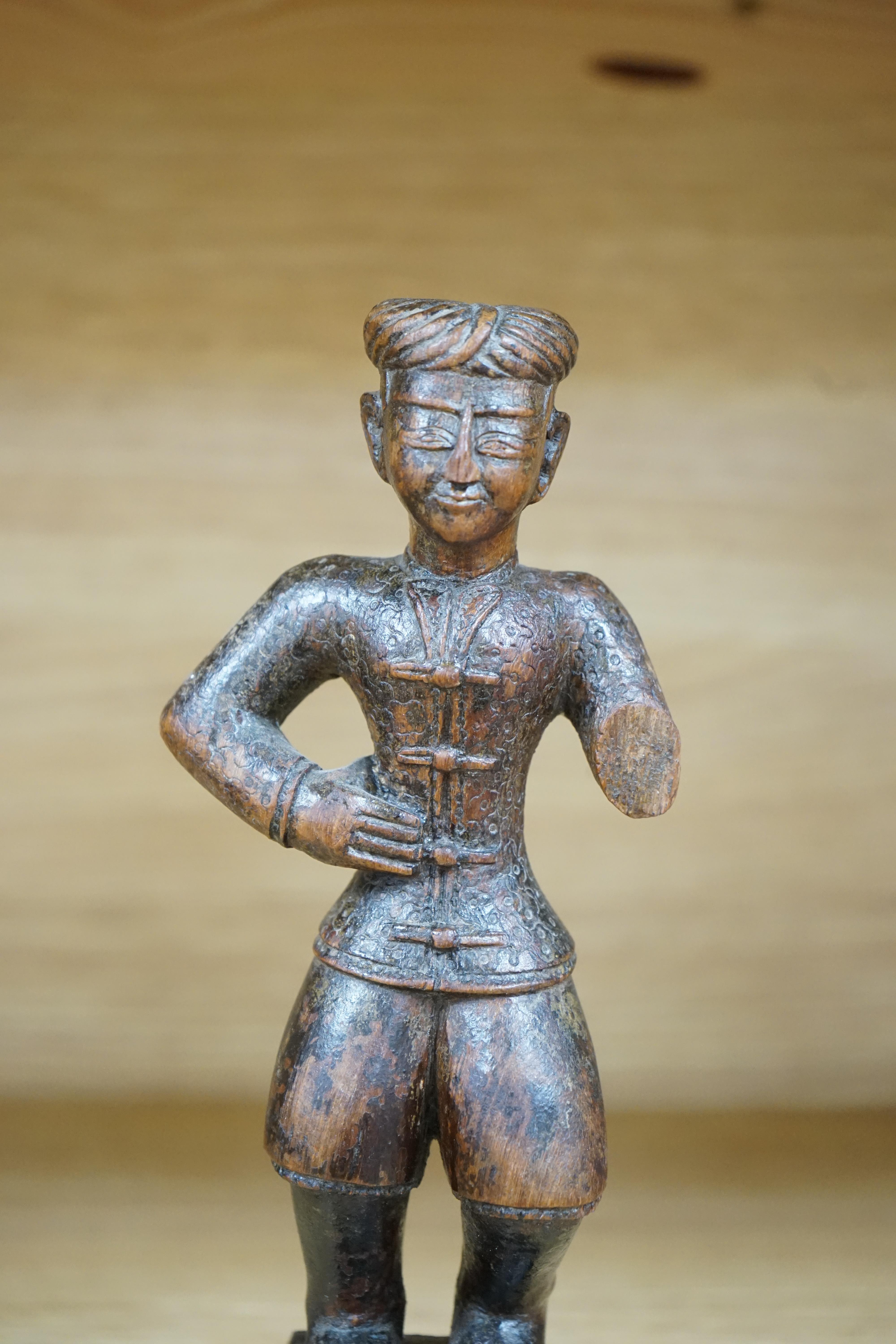 A 19th century Indian carved wood figure of a man, 23cm high. Condition - poor to fair, one arm missing